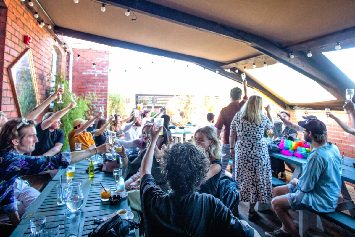 people raising glasses on outdoor terrace